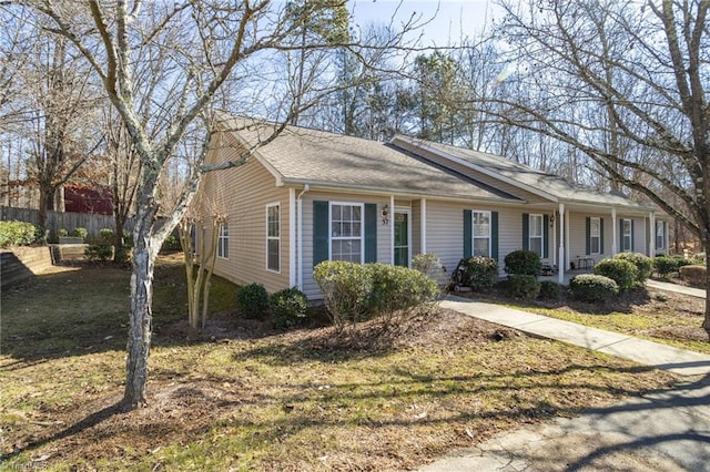 ranch-style house featuring a front lawn and covered porch