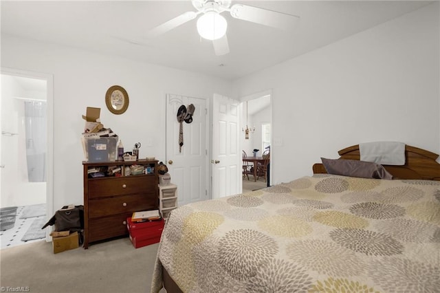 bedroom featuring ceiling fan, ensuite bath, and light colored carpet