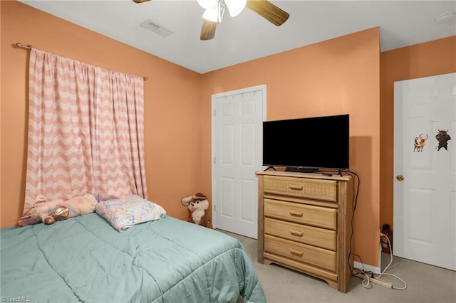 bedroom with light carpet and ceiling fan