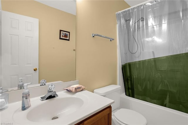 full bathroom with vanity, shower / tub combo with curtain, and toilet