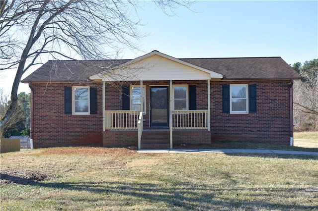 view of front of house with covered porch and a front lawn