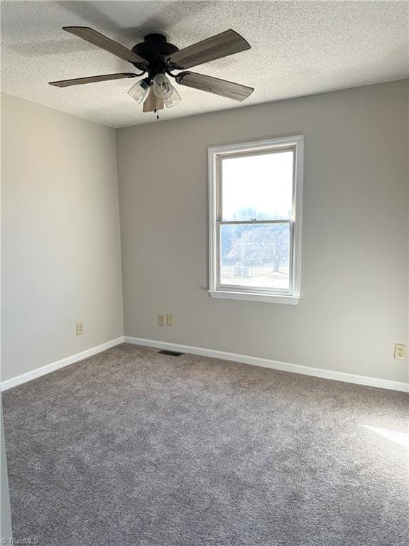 empty room with carpet, ceiling fan, and a textured ceiling