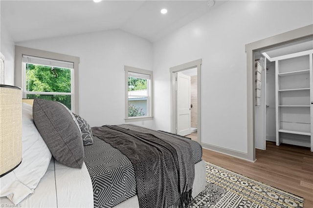 502 Eighth St, Mebane, NC 27302 - bedroom with wood finished floors, a spacious closet, lofted ceiling, recessed lighting, and ensuite bath