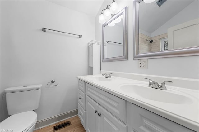 502 Eighth St, Mebane, NC 27302 - full bathroom featuring double vanity, lofted ceiling, and wood finished floors