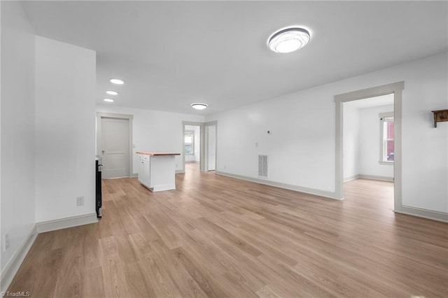 502 Eighth St, Mebane, NC 27302 - unfurnished living room featuring plenty of natural light, light wood-type flooring, and recessed lighting