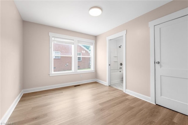 502 Eighth St, Mebane, NC 27302 - unfurnished bedroom featuring light wood-style floors and ensuite bath