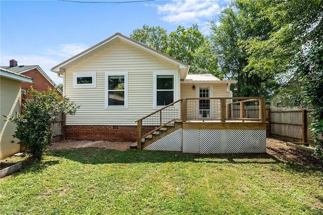502 Eighth St, Mebane, NC 27302 - back of property featuring a wooden deck, a fenced backyard, crawl space, stairs, and a metal roof