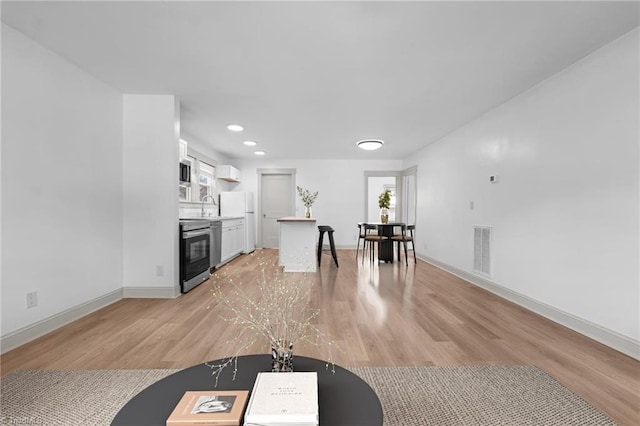502 Eighth St, Mebane, NC 27302 - living area with light wood-style floors and recessed lighting