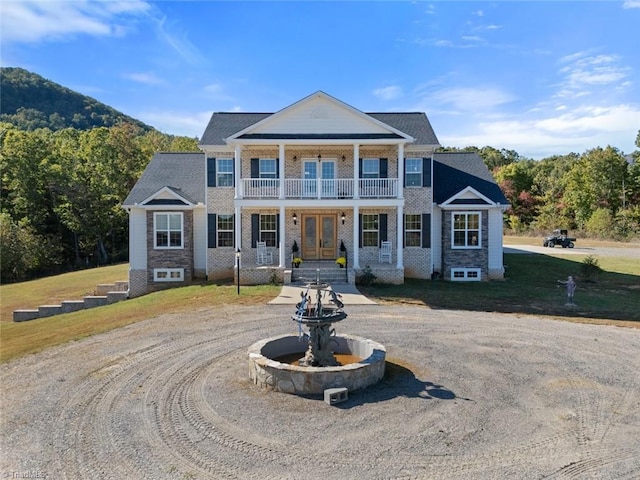 greek revival house with a mountain view and a balcony