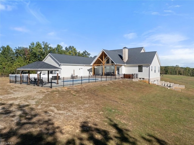 rear view of property with a patio and a lawn