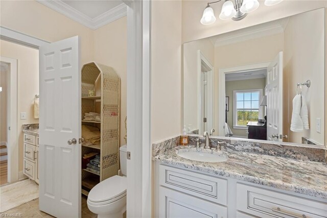 bathroom featuring vanity, ornamental molding, toilet, and tile patterned flooring