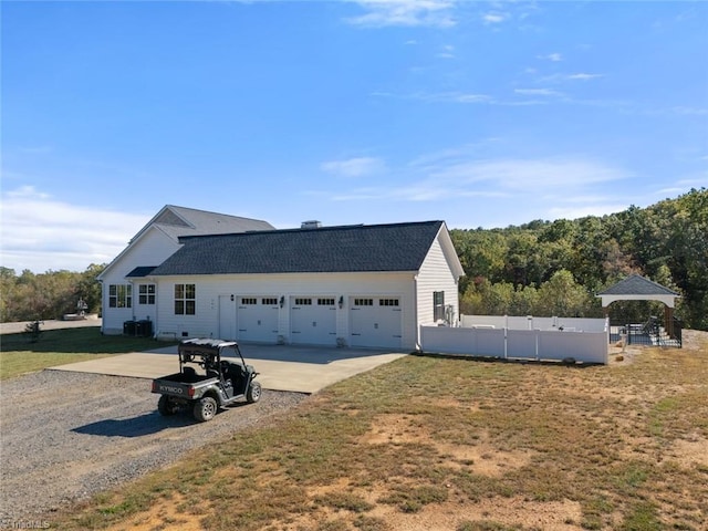 view of front of property with a gazebo, a front yard, and a garage