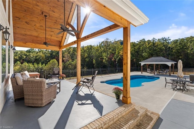 view of swimming pool with a patio, a gazebo, and ceiling fan