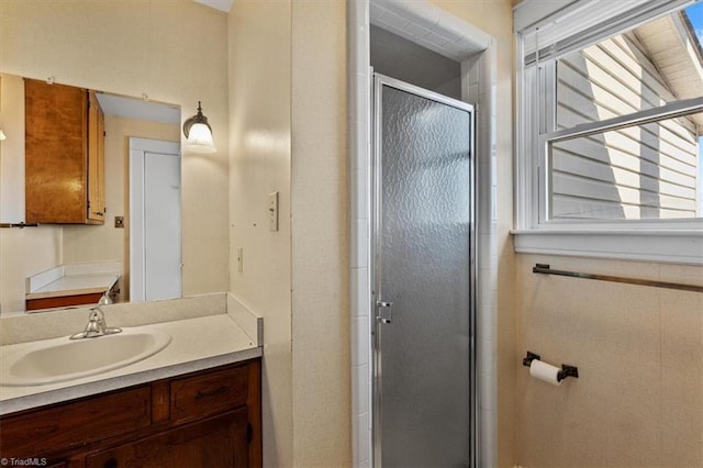 full bath with vanity, plenty of natural light, and a stall shower