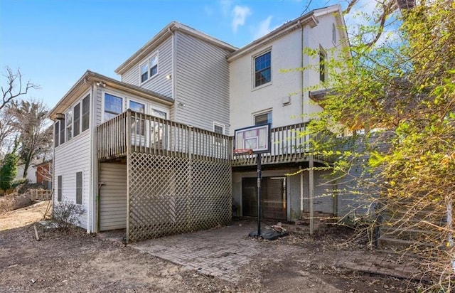 back of house featuring a deck