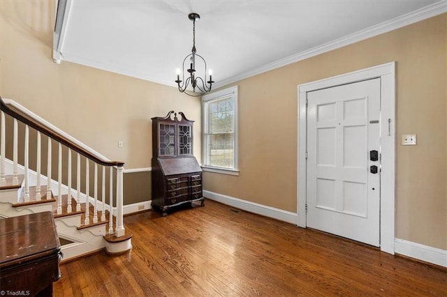 entryway featuring crown molding, stairs, baseboards, and wood finished floors