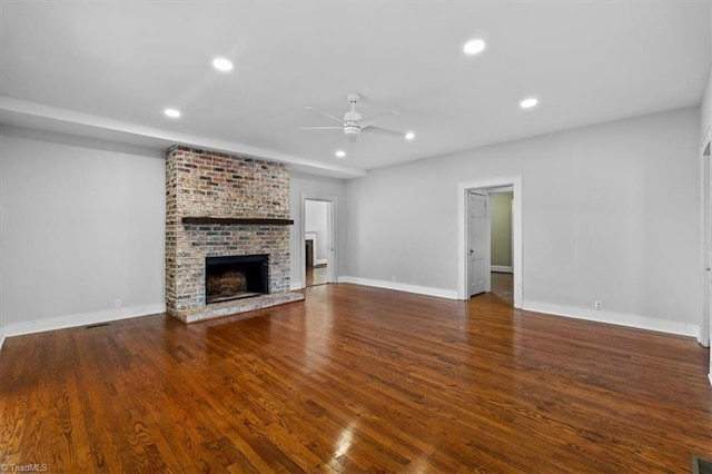 unfurnished living room featuring recessed lighting, a ceiling fan, wood finished floors, and a fireplace