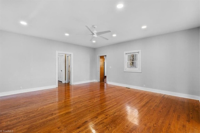 empty room featuring recessed lighting, baseboards, a ceiling fan, and wood finished floors