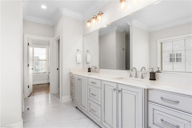 bathroom with ornamental molding and vanity