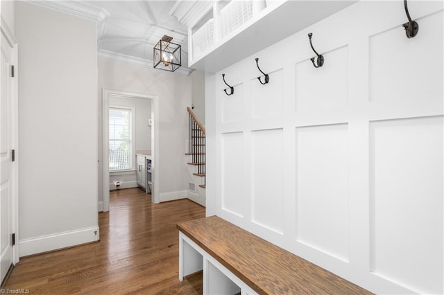 mudroom with an inviting chandelier, ornamental molding, and dark hardwood / wood-style floors