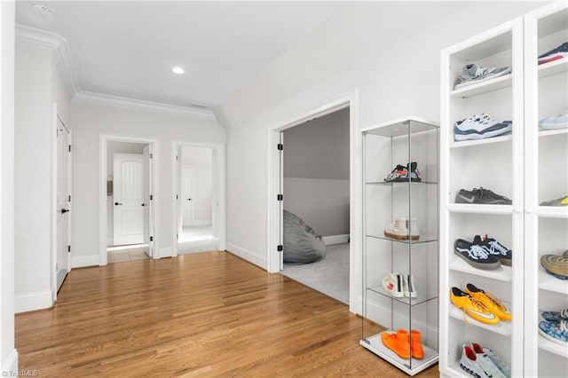 hallway featuring crown molding and hardwood / wood-style floors