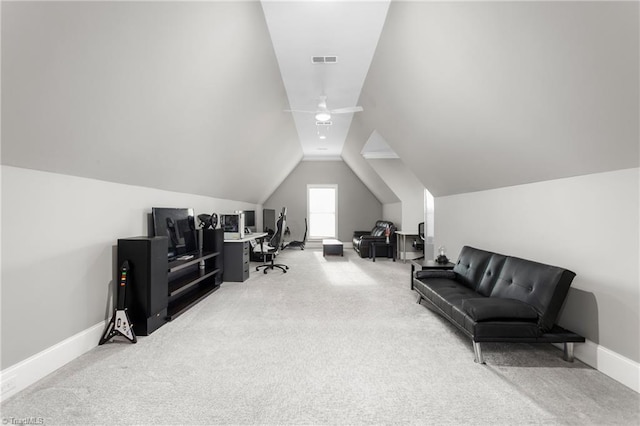 carpeted office space featuring lofted ceiling and ceiling fan