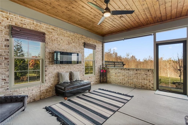 sunroom / solarium with ceiling fan and wooden ceiling