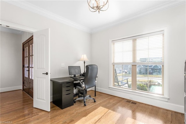 office with light hardwood / wood-style flooring, a notable chandelier, a wealth of natural light, and ornamental molding