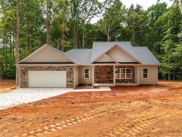 ranch-style house with a garage, stone siding, a shingled roof, and covered porch