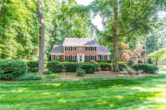 colonial-style house with a front yard