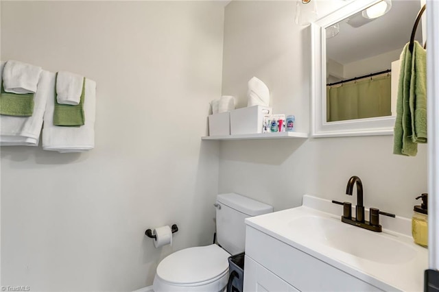 bathroom featuring vanity and toilet