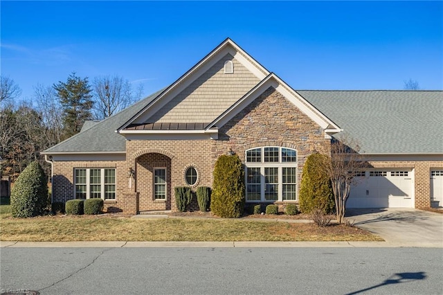 view of front of house featuring a garage and a front lawn