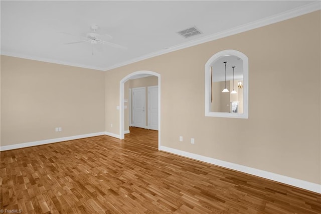 unfurnished room with ceiling fan, ornamental molding, and wood-type flooring