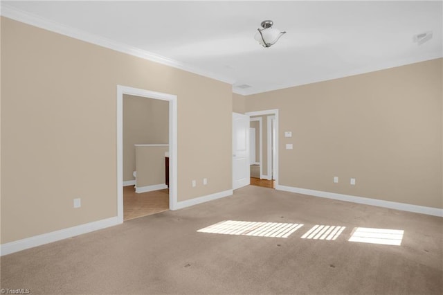 carpeted spare room featuring ornamental molding