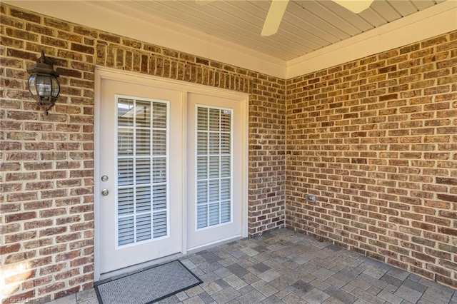 view of exterior entry with a patio area