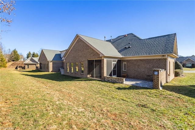 back of property featuring a patio and a yard