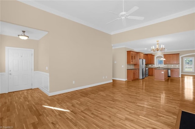 unfurnished living room with ornamental molding, light hardwood / wood-style floors, and ceiling fan