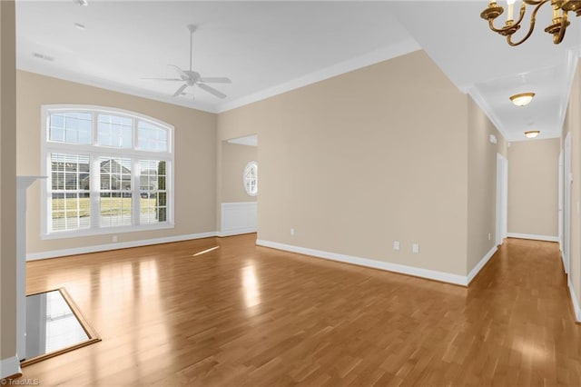 unfurnished living room featuring crown molding, wood-type flooring, and ceiling fan with notable chandelier