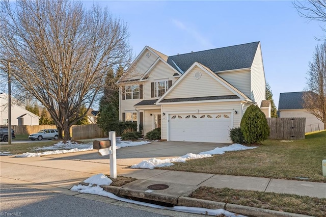 view of front of home with a front lawn and a garage