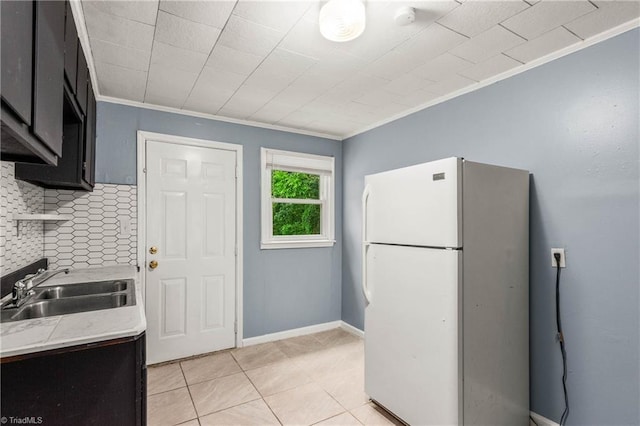 415 White Oak St, High Point, NC 27260 - kitchen featuring freestanding refrigerator, crown molding, tasteful backsplash, light countertops, and light tile patterned floors