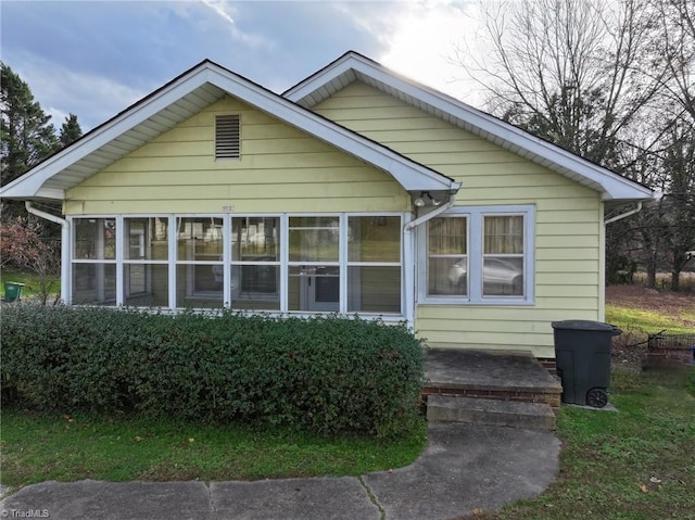 view of front of home featuring a sunroom