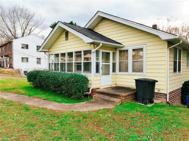 1610 S Main St, Mount Airy, NC 27030 - back of house featuring a sunroom, a yard, and a chimney