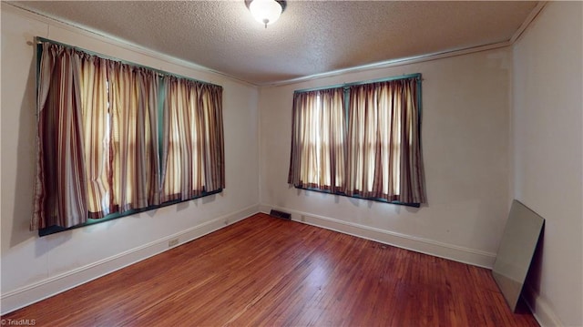 1610 S Main St, Mount Airy, NC 27030 - empty room with a textured ceiling, wood finished floors, and baseboards