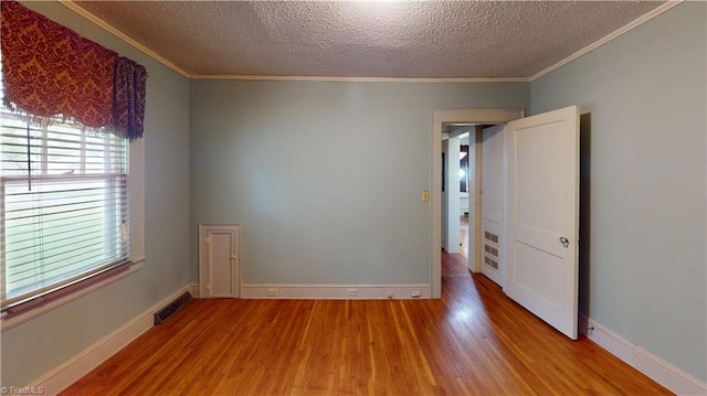 1610 S Main St, Mount Airy, NC 27030 - unfurnished room with wood finished floors, ornamental molding, a textured ceiling, and baseboards