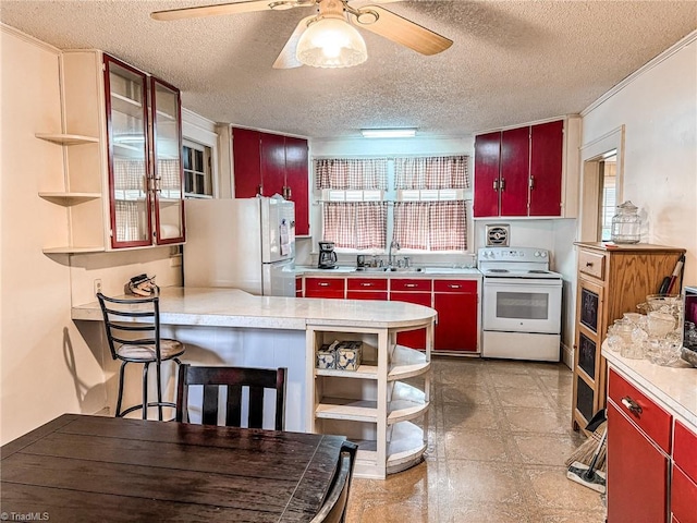 kitchen with sink, a textured ceiling, fridge, and electric stove