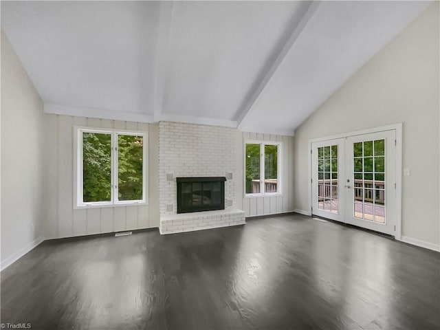 unfurnished living room featuring vaulted ceiling with beams, dark hardwood / wood-style flooring, french doors, and a brick fireplace