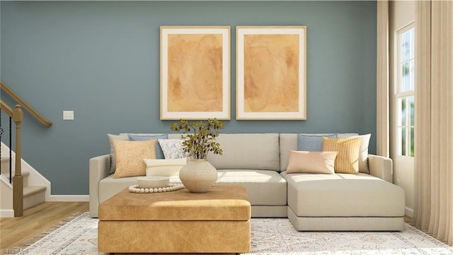 sitting room featuring baseboards, stairway, and wood finished floors