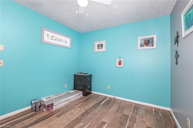 6517 Benson Ln, Pfafftown, NC 27040 - unfurnished bedroom with wood finished floors, a textured ceiling, and a ceiling fan