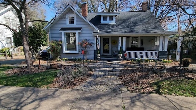 bungalow-style home with a porch and a chimney