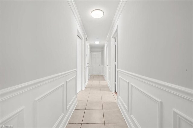 3523 Riverside Dr, Greensboro, NC 27406 - hall with light tile patterned flooring, a decorative wall, and wainscoting